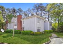 Inviting condo complex featuring manicured lawns and lush landscaping at 4307 Orchard Park Ct # A, Stone Mountain, GA 30083