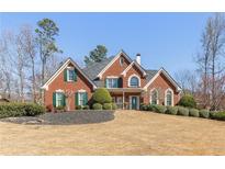 Beautiful brick home with lush landscaping and manicured lawn on a sunny day at 1414 Lynchburg Trce, Grayson, GA 30017