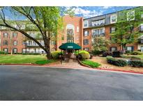 Elegant brick building with a welcoming green awning, well-maintained landscaping, and classic architectural design at 28315 Plantation Ne Dr, Atlanta, GA 30324