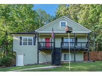 Charming two-story home with a covered front porch and beautiful green lawn at 260 Sterling Dr, Powder Springs, GA 30127