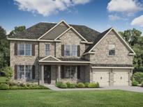 Charming two-story home with brick facade, shuttered windows, and a well-manicured front lawn at 3265 Lions Ruby Ln, Atlanta, GA 30349