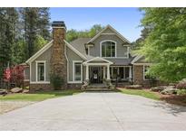 Charming two-story home with stone accents, a welcoming front porch, and a spacious driveway at 5655 Mccoy Rd Nw, Acworth, GA 30101