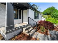 Inviting front door with black trimmed windows and manicured landscaping at 981 Northrope Ne Dr, Atlanta, GA 30324