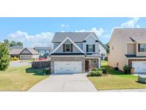 Charming two-story home with stone accents, a two-car garage, and a well-manicured lawn at 113 Cottage Walk, Cartersville, GA 30121