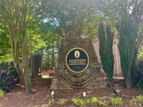 Stone sign for Thorncrest community, surrounded by greenery and trees, establishing a welcoming atmosphere at 6158 Thorncrest Dr, Tucker, GA 30084