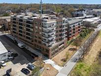Beautiful condo building with brick facade, balconies, and walkable paths at 675 Drewry Ne St # 303, Atlanta, GA 30306