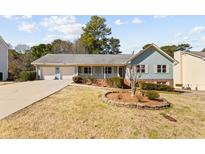 Charming single-story home with well-maintained landscaping and a two-car garage, perfect for suburban living at 2003 Graystone Pkwy, Grayson, GA 30017