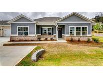Charming single-Gathering home with a well-manicured lawn and attractive brick accents at 3855 Shelleydale Dr, Powder Springs, GA 30127