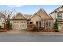 Charming home with a brick driveway and a well-manicured lawn at 115 Batten Board Way Way, Woodstock, GA 30189