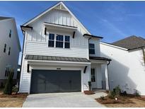 Charming two-story home features white siding, a gray garage door, and a well-manicured front yard at 629 Skytop Dr, Cumming, GA 30040