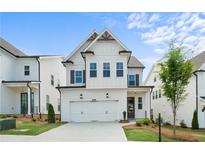 New construction home with white siding, a two-car garage, and manicured landscaping at 631 Skytop Dr, Cumming, GA 30040