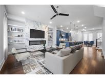 Open-concept living room featuring a marble fireplace, built-in shelving, and modern furnishings at 1048 Claudette Colvin Ct, Atlanta, GA 30318