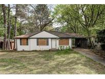 Quaint, single story home with white brick, dark trim and carport at 1809 San Gabriel Ave, Decatur, GA 30032