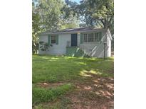 Traditional one-story home with painted brick, dark roof, green shutters, and an unkempt front yard at 2168 Clanton Ter, Decatur, GA 30034