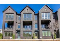 View of the townhouse-style home boasting dark brick, multiple windows, and private balconies at 2620 Mackintosh Ct # 19, Brookhaven, GA 30319