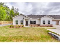 Charming single-story home with a well-manicured lawn, complemented by a mix of brick and white wood siding at 3908 Shelleydale Dr, Powder Springs, GA 30127