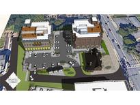 A vibrant aerial view of the mixed-use development showcasing the building exteriors and parking area at 120 N Main St # 2A, Alpharetta, GA 30009