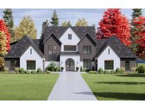 Stunning exterior with a symmetrical facade, manicured lawn and beautiful landscaping at 1280 Tynecastle Way, Sandy Springs, GA 30350