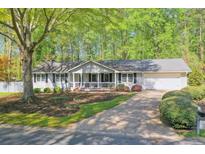 Charming ranch-style home with a well-manicured front yard and a welcoming porch at 1590 Arden Sw Dr, Marietta, GA 30008