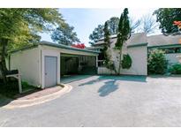 Charming single-Gathering home featuring an attached carport and mature trees at 4964 N Ellipse Dr, Marietta, GA 30068
