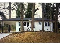 Charming single-story white home with a black trim, car port, and a front porch with black railings at 2804 Dearwood Sw Dr, Atlanta, GA 30315