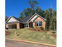 A charming brick home with a well-manicured lawn and an attached two-car garage at 5007 Fairview Cir, Villa Rica, GA 30180