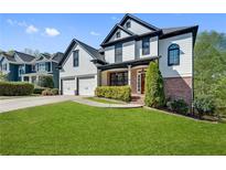 Beautiful two-story home featuring a well-manicured lawn and a two-car garage at 3085 Woodbridge Ln, Canton, GA 30114