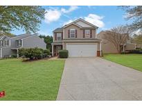 Charming two-story home with a well-maintained lawn, two-car garage, and inviting curb appeal at 2480 Sheldon Pl, Cumming, GA 30040