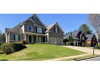 Beautiful two-story home with a well-manicured lawn and a stone and siding facade at 31 Vine Creek Ln, Acworth, GA 30101