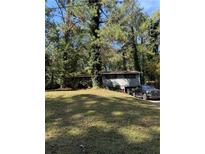 View of the exterior of the home with large front yard at 865 Cherrydale Ln, Woodstock, GA 30189