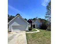 Charming single-Gathering home featuring a well-maintained lawn, a two-car garage, and inviting curb appeal at 206 Towler Dr, Loganville, GA 30052