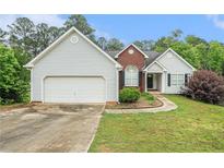 Charming single Gathering home featuring vinyl siding, brick accents, and a well manicured lawn at 206 Towler Dr, Loganville, GA 30052