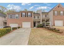 Charming townhome showcasing a brick facade, attached garage, and well-maintained front yard at 331 Parkview Manor Dr, Tucker, GA 30084