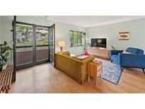 Inviting living room features hardwood floors, cozy seating, and French doors at 1380 Chalmette Ne Dr # 3, Atlanta, GA 30306