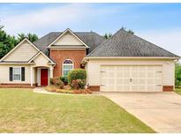 Charming single-Gathering home with brick and vinyl siding, complemented by a well-manicured lawn and mature landscaping at 57 Craig Meadows Ln, Douglasville, GA 30134