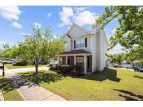 Charming two-story home with stone accents, landscaped front yard, and a sidewalk at 1016 Borrington Ln, Stockbridge, GA 30281