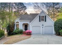 Charming single-Gathering home with gray siding, a two-car garage, and beautiful landscaping at 3711 Spinnaker Cir, Alpharetta, GA 30005