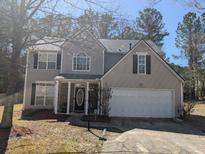 Charming two-story home featuring neutral siding, black shutters, and an attached two-car garage at 3967 Moos Creek Ct, Loganville, GA 30052