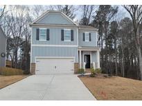 Charming two-story home with a two car garage, light blue siding and black shutters at 6615 Bluffview Dr, Douglasville, GA 30134