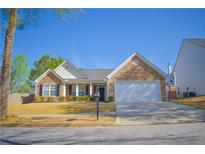 Charming single-story home with stone facade, manicured lawn, and attached two-car garage at 3851 Bogan Mill Rd, Buford, GA 30519
