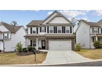Charming two-story home featuring a two-car garage, landscaped yard, and a welcoming entrance at 531 S Fortune Way, Dallas, GA 30157