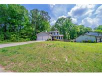Charming two-story home with attached two-car garage and landscaped yard at 1171 Bailing Dr, Lawrenceville, GA 30043