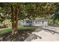 Charming single-story home with light gray siding, green lawn and long driveway at 5725 Brenda Sw Dr, Mableton, GA 30126
