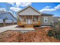 Charming home featuring a welcoming front porch and newly installed concrete driveway at 515 Federal Se Ter, Atlanta, GA 30315