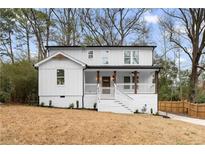 Charming two-story home features a white exterior, inviting front porch, and well-maintained landscaping at 770 Waters Sw Dr, Atlanta, GA 30310