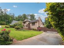 Charming two-story home with well-maintained landscaping, long driveway, and inviting entrance at 3730 Willow Mill Dr, Lawrenceville, GA 30044