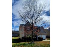 Charming two-story home featuring a two-car garage and well-maintained landscaping at 237 Summergate Ln, Villa Rica, GA 30180