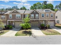 Charming townhouse exterior with well-maintained landscaping and neutral color scheme at 5157 Madeline, Stone Mountain, GA 30083