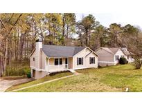 Charming single-story home with a well-maintained front yard and classic architectural details at 6092 Leverett Dr, Lithonia, GA 30038