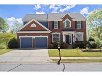 Charming two-story brick home with a well-manicured lawn and attached two-car garage at 3950 Almandine Way, Cumming, GA 30040